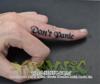 Calligraphy text on side of middle finger